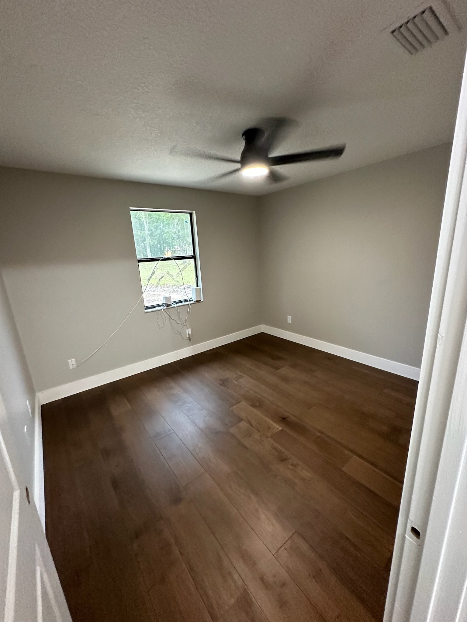 Bedroom after engineered wood flooring remodel in Middleburg FL
