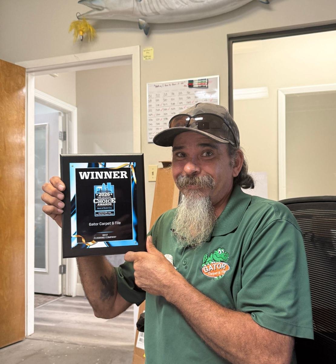 Gary from Gator Carpet and Tile holding the 2026 Best Flooring Company plaque