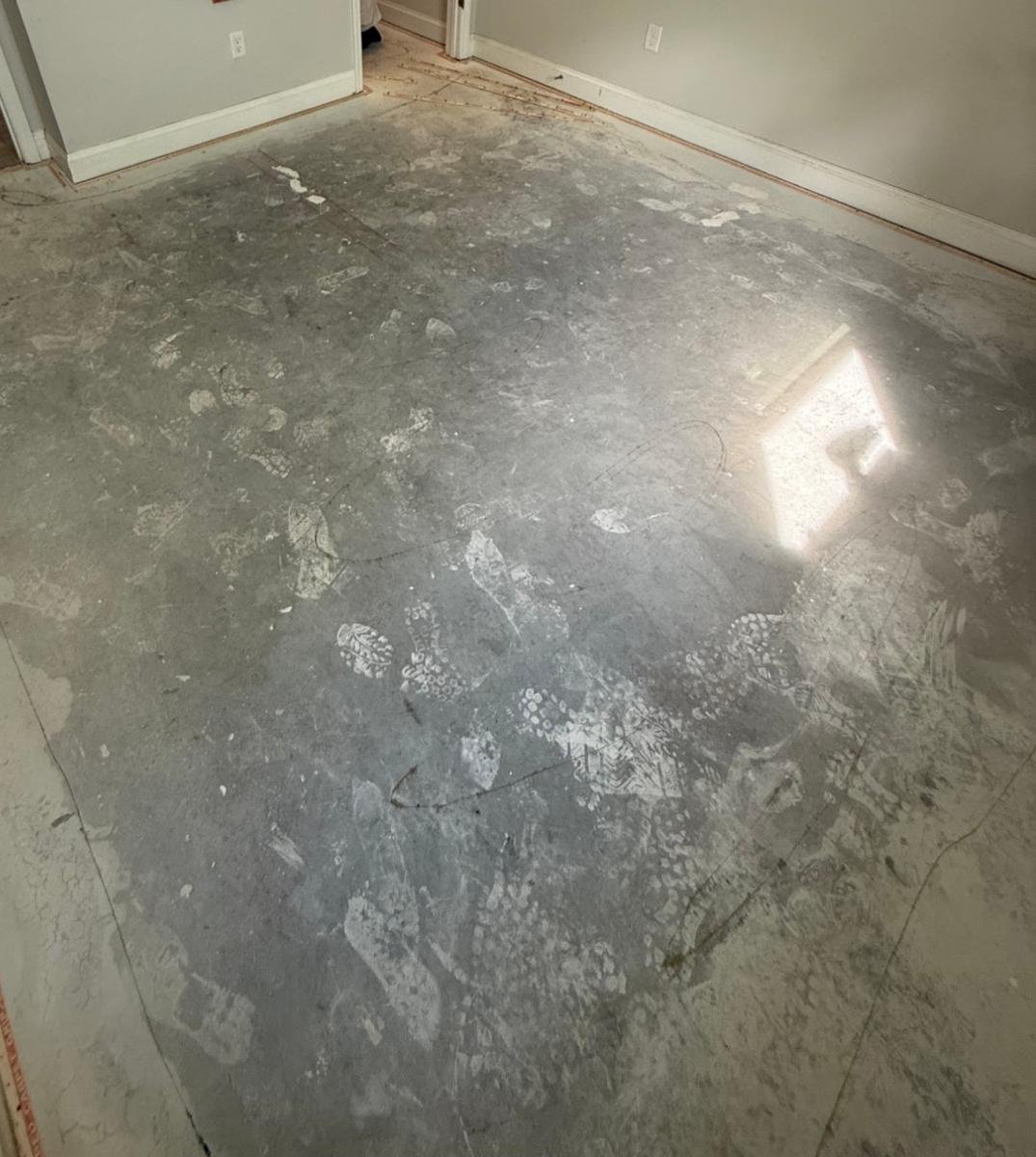 Old flooring removed down to the concrete slab before new carpet in Jacksonville