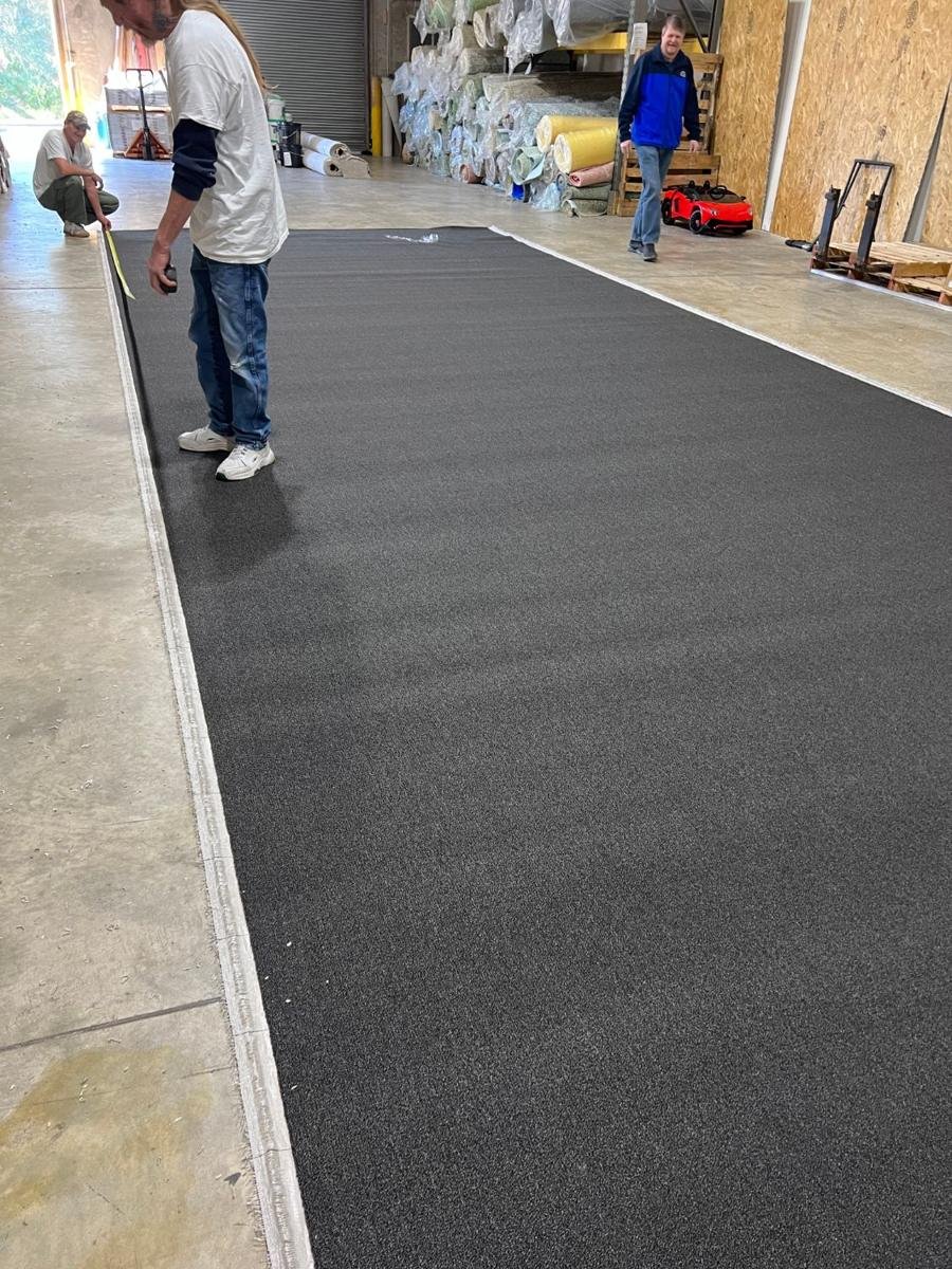 Gator crew measuring and cutting commercial carpet in the Jacksonville warehouse