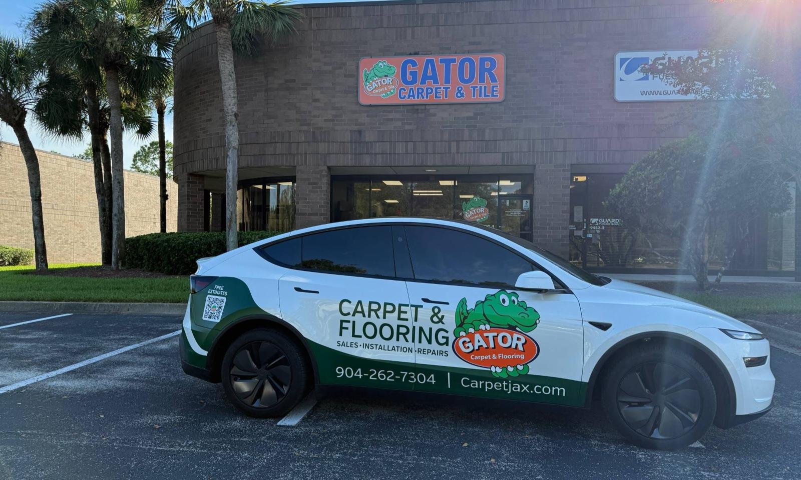 Gator Carpet and Tile showroom storefront at 9452 Philips Highway, Jacksonville, with the Gator wrapped vehicle