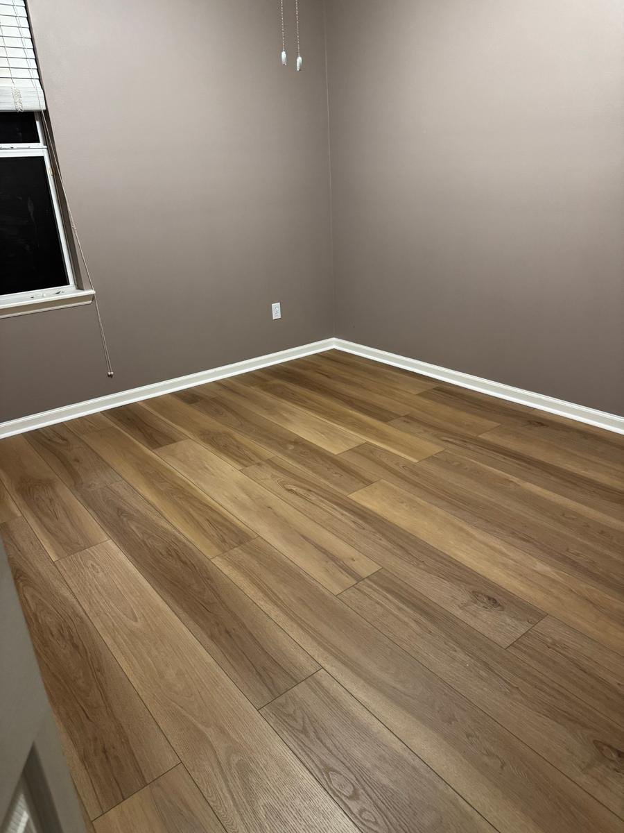 Vinyl plank flooring run into the corners of a Northside Jacksonville bedroom