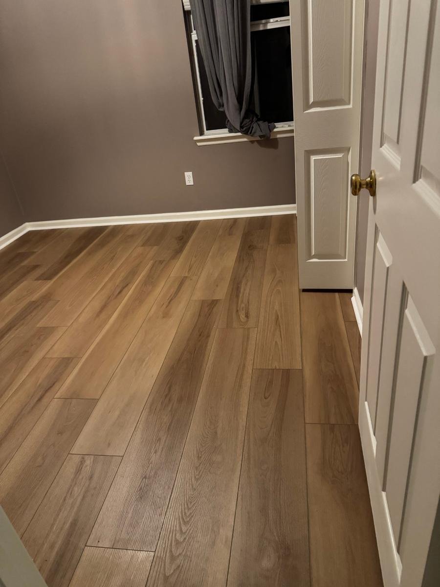 View from the doorway of new luxury vinyl plank in a Northside Jacksonville bedroom