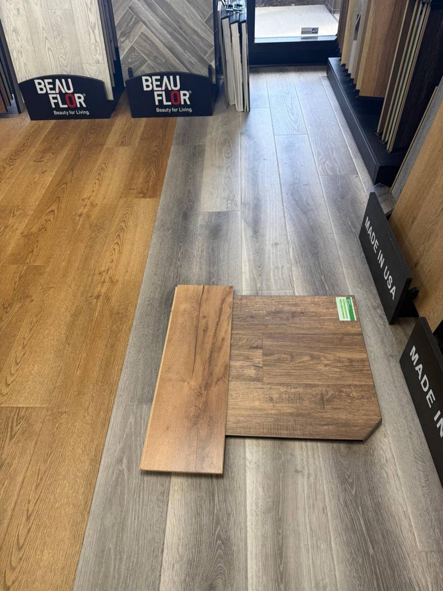 Luxury vinyl plank and laminate samples on the floor of the Gator Carpet and Tile Jacksonville showroom