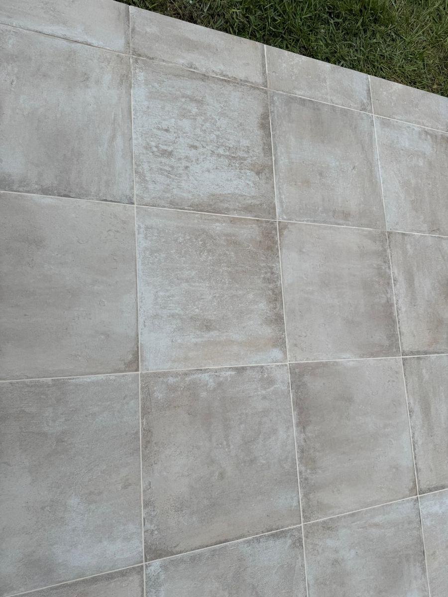 Porcelain patio tile finished at the lawn edge in World Golf Village, St. Augustine, FL