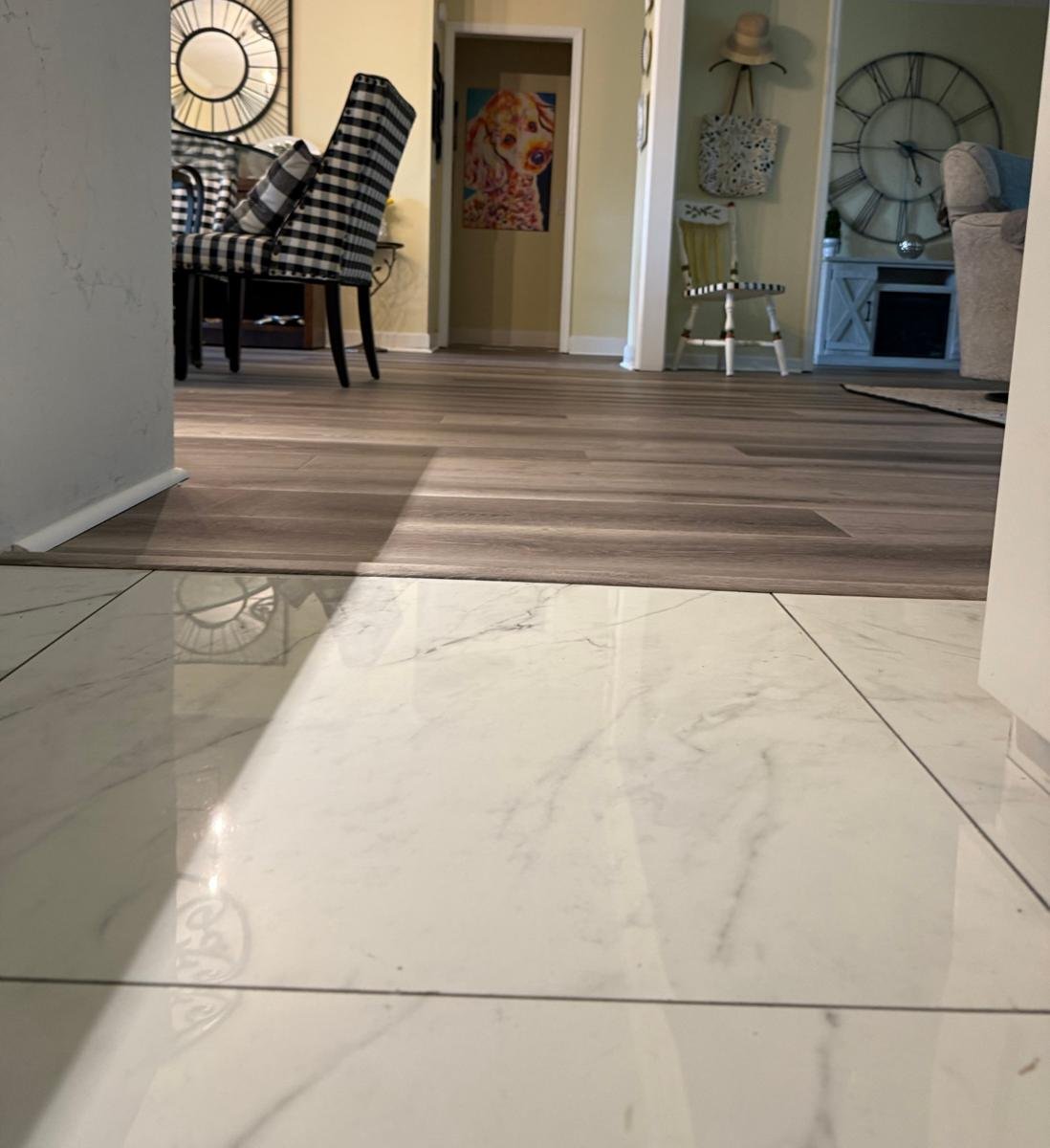 Close view of the new LVP transition at the existing kitchen tile in a Mandarin home