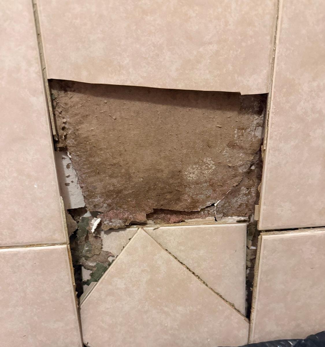Water-damaged wallboard behind failed shower tile in Mandarin, Jacksonville
